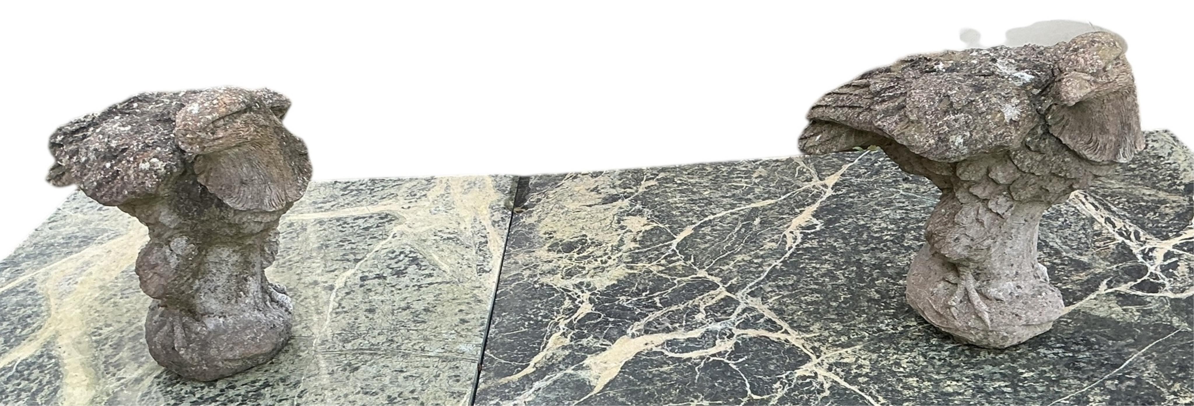 A pair of reconstituted stone models of eagles, height 34cm